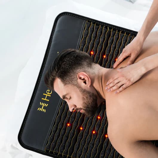 Man experiencing back massage on HealthyLine JET PEMF Mat for muscle recovery