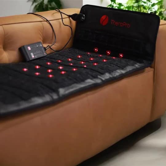 Therasage TheraPro PEMF Mat placed on home sofa for relaxing red light and PEMF therapy session