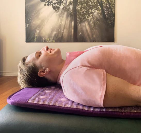Close headshot of man unwinding on Sparkle PEMF therapy mat for stress relief
