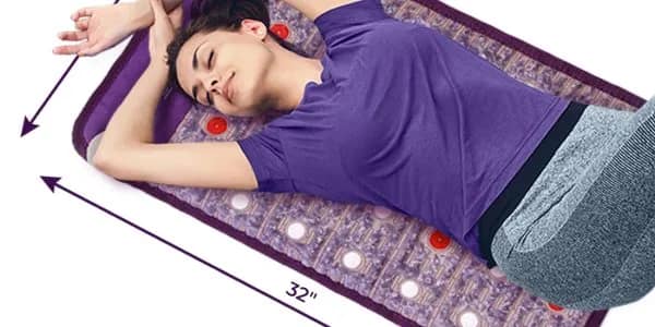 User resting on Sparkle PEMF MiniMat for muscle recovery and improved circulation