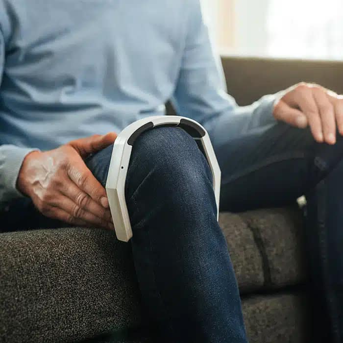 OmniPEMF NeoRhythm positioned on the knee for PEMF therapy and joint pain relief