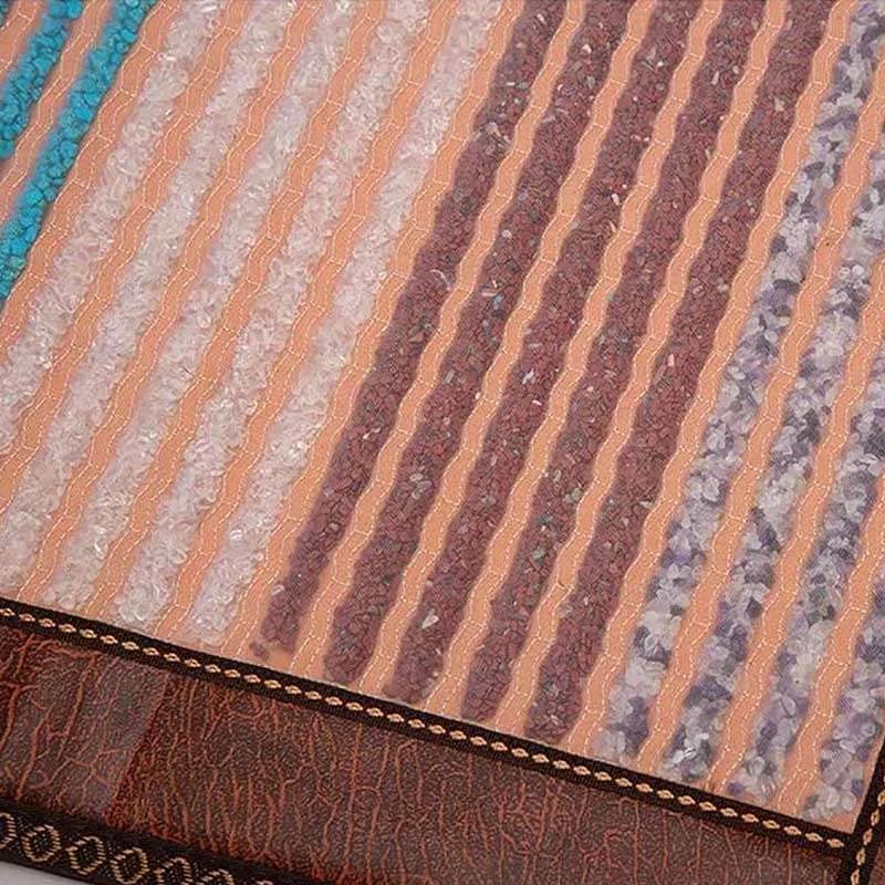 Close-up detail of Phymat Chakra PEMF mat surface showing colorful gemstones and texture