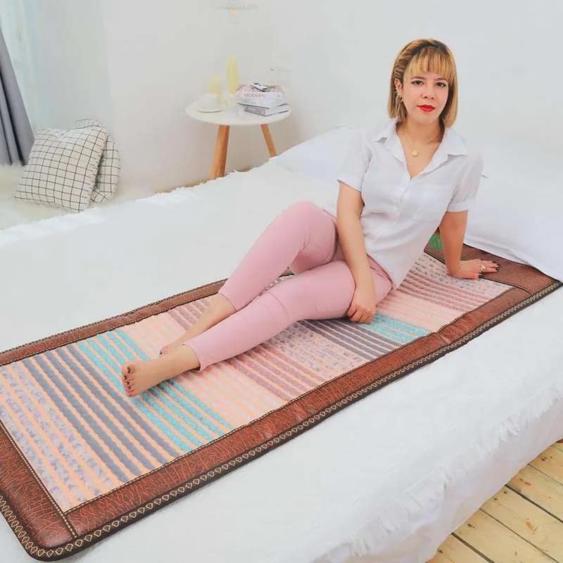 Relaxed woman using Phymat Chakra PEMF mat for wellness and energy flow