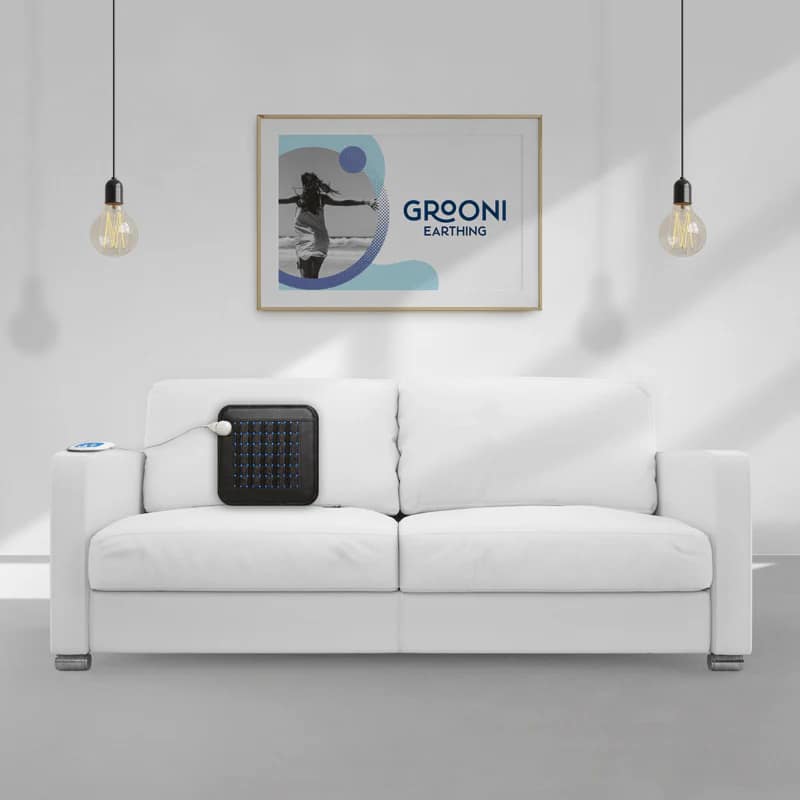 Grooni Earthing PEMF Pad resting on couch for home therapy