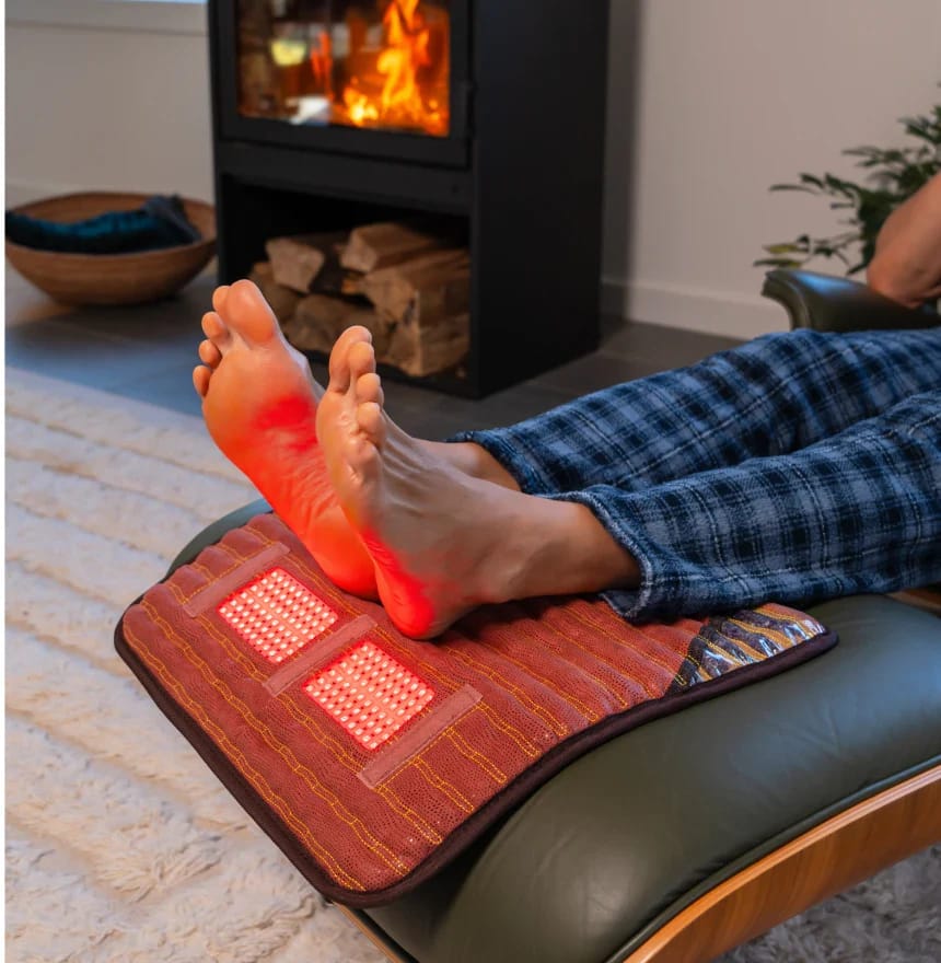 Feet receiving red light therapy on HealthyLine TAO PEMF Pad for circulation and pain management