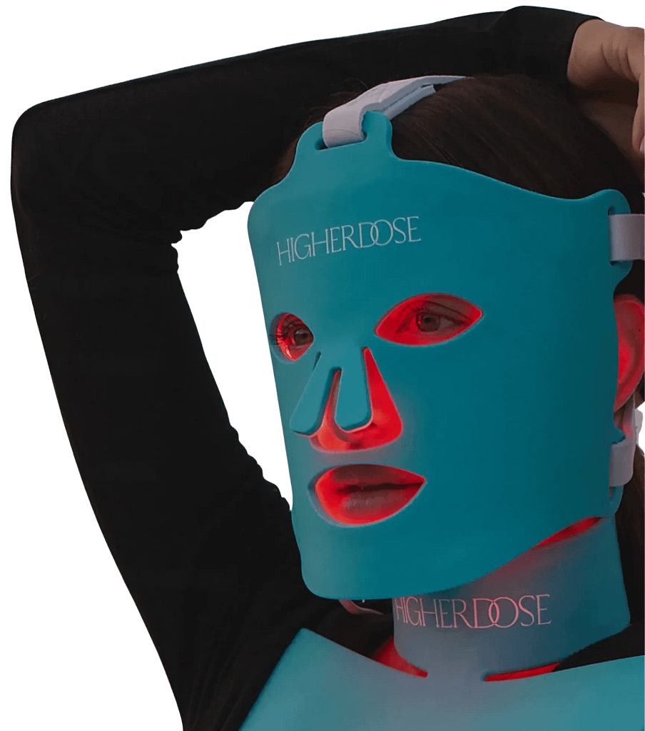 Woman showcasing Higherdose red light therapy face mask
