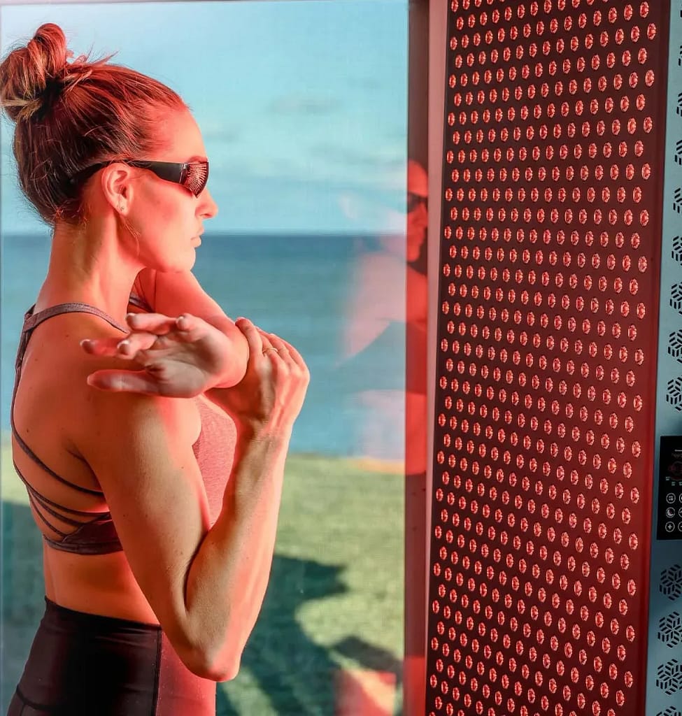 Woman with eye protection glasses in front of Hooga 4500 Red Light Panel