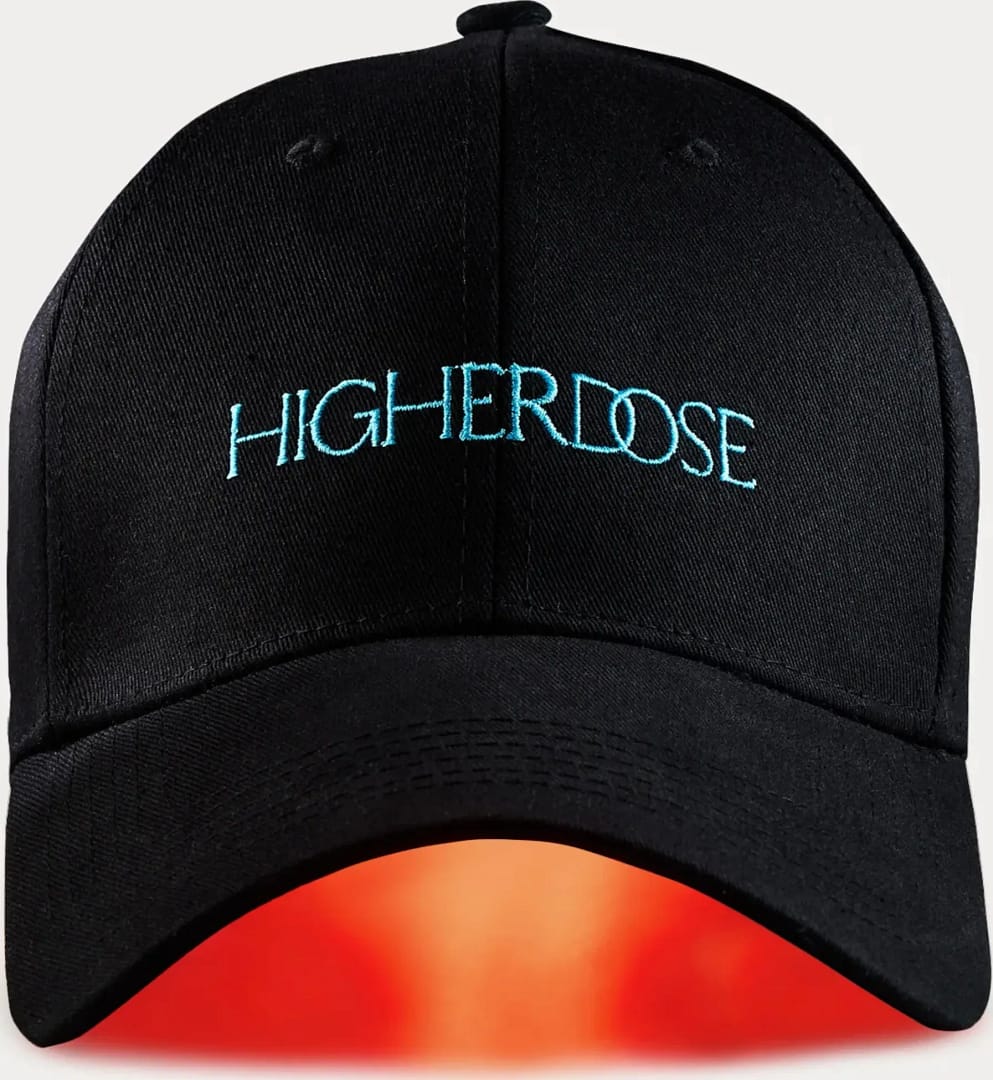 HigherDose wireless LED Hat illuminated showing battery-powered red light therapy in action