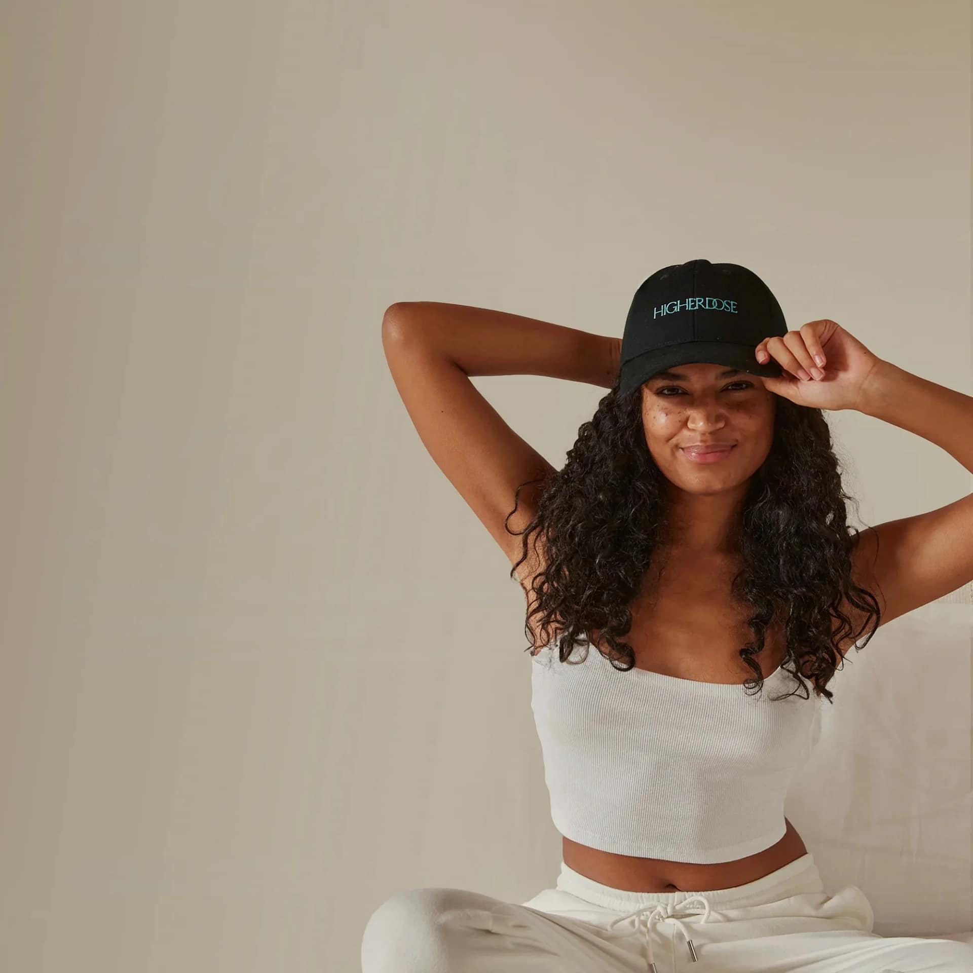 Woman wearing the HigherDose red light hat