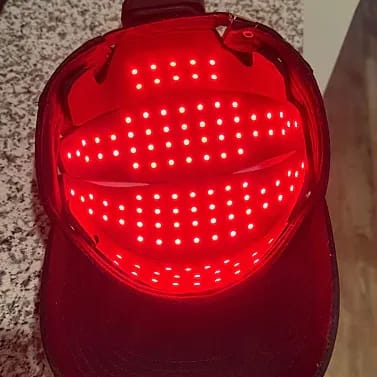Interior view of HigherDose LED Hat displaying activated wireless red light array for scalp therapy
