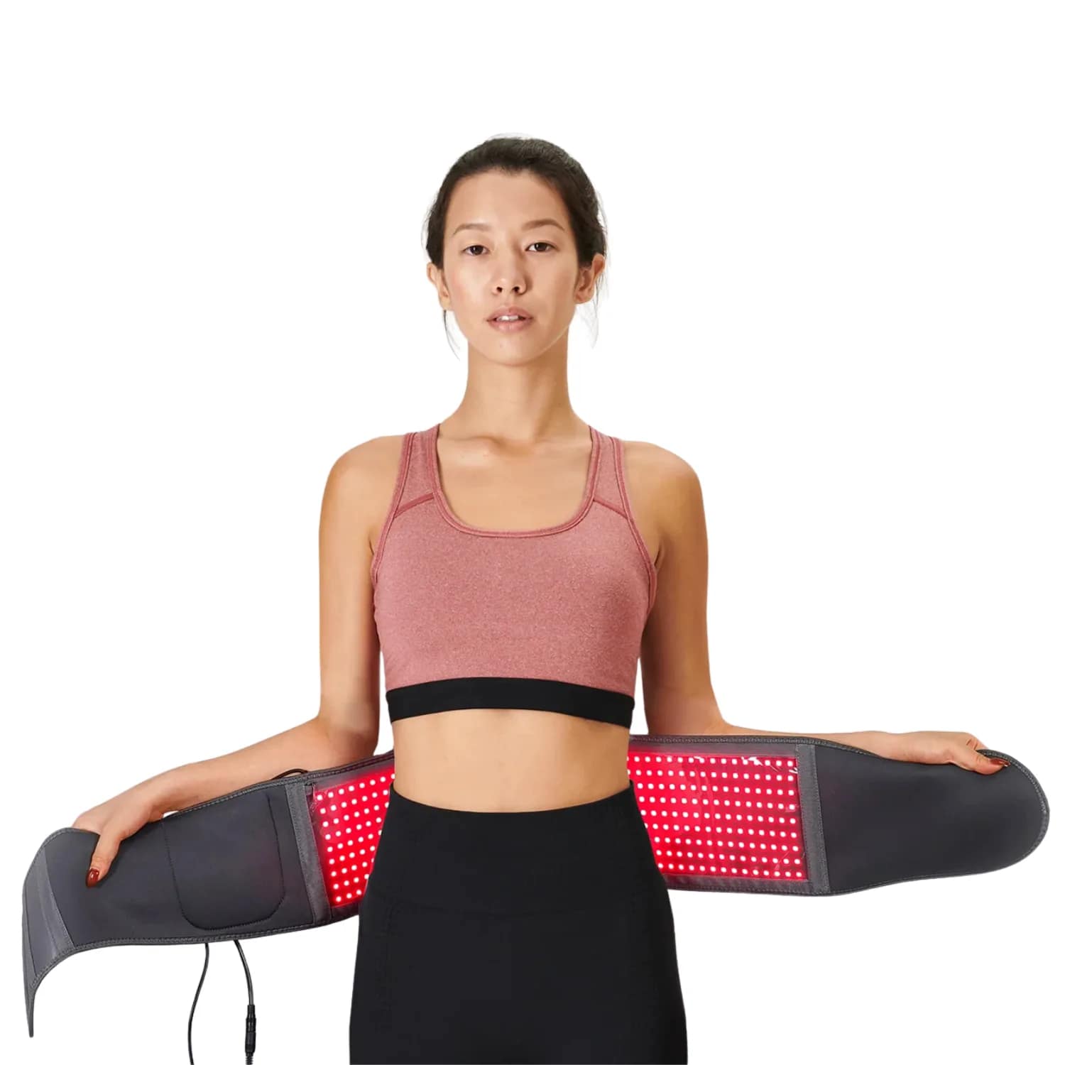 Woman wrapping Hooga Red Light Therapy Belt around waist for abdominal and lower back pain treatment