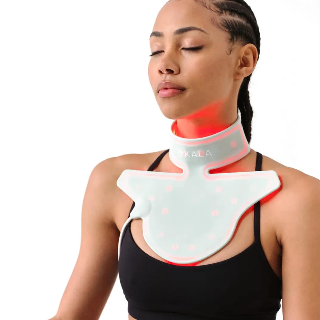 Woman using the Kala Red Light Therapy Neck