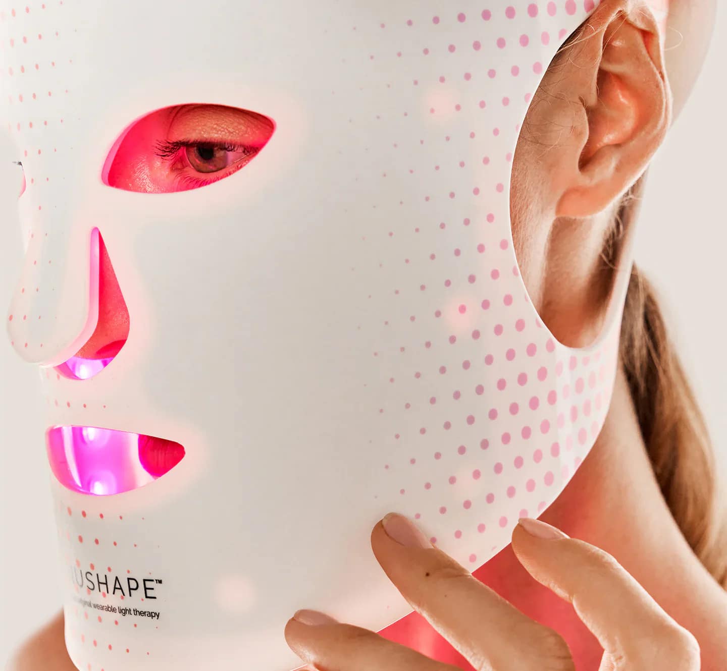 Close-up view of Nushape Mask LED panel illuminated with red wavelength therapy
