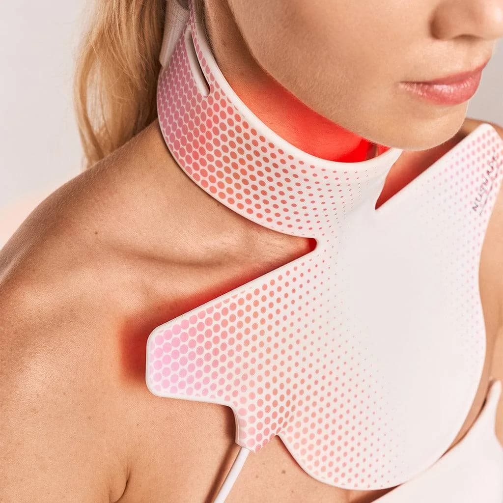Overhead view of woman using Nushape Neck Rejuvenator for hands-free portable LED therapy session